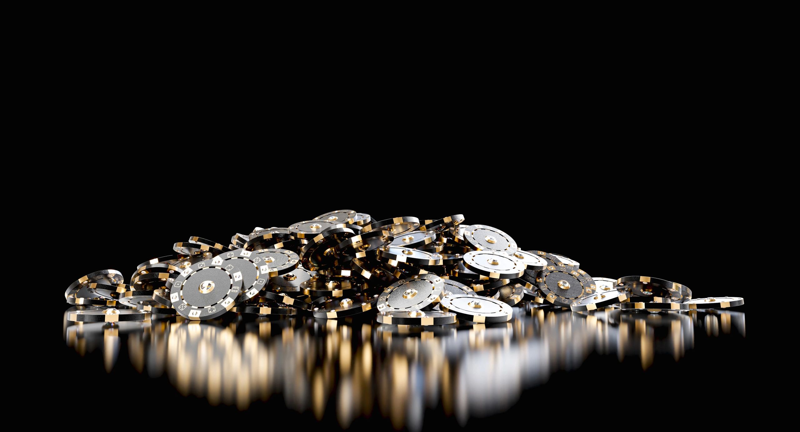 Black and gold poker chips on a reflective surface